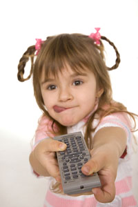 Joyful little girl with TV remote